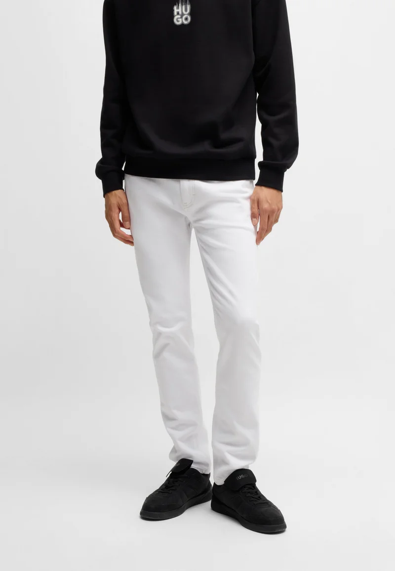 هوجو جينز أبيض بقصة ضيقة من قماش دينم مطاطي