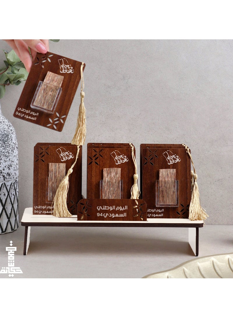 Story Of Candle A wooden stand containing 12 luxurious natural oud cards bearing the 94rd Saudi National Day logo 