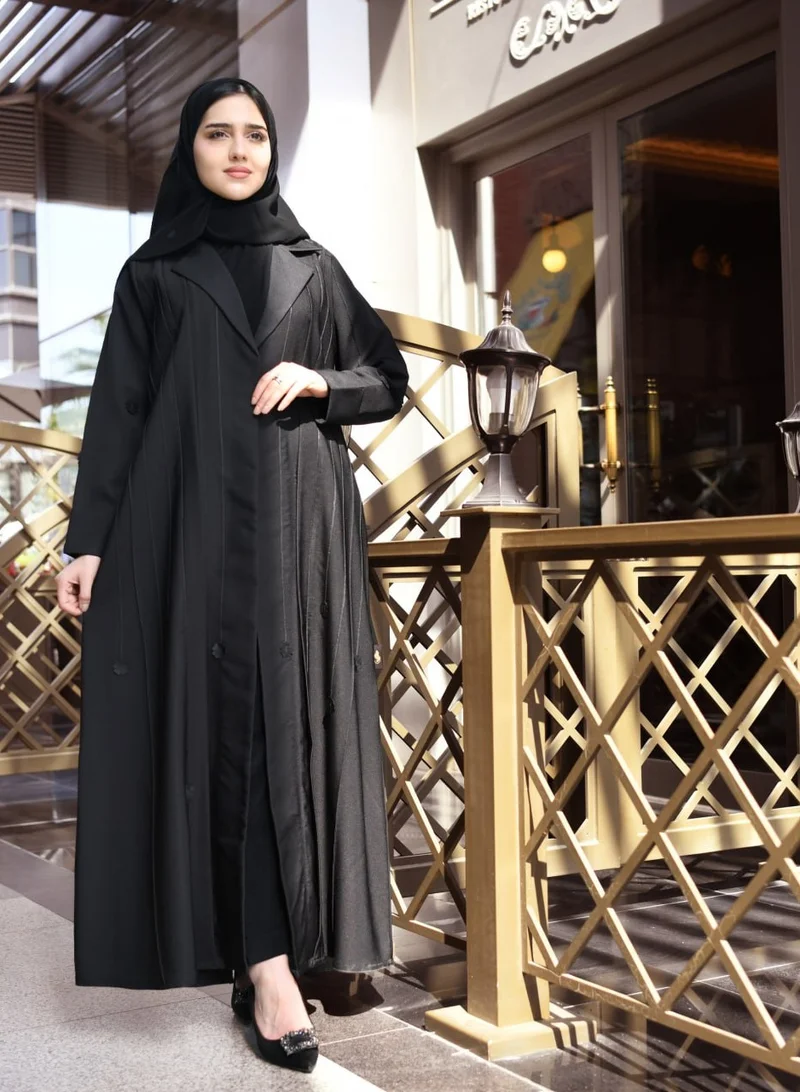 HAWRAA ABAYA Black quarter-cloche abaya with formal cut, decorated with black ribbons and flowers
