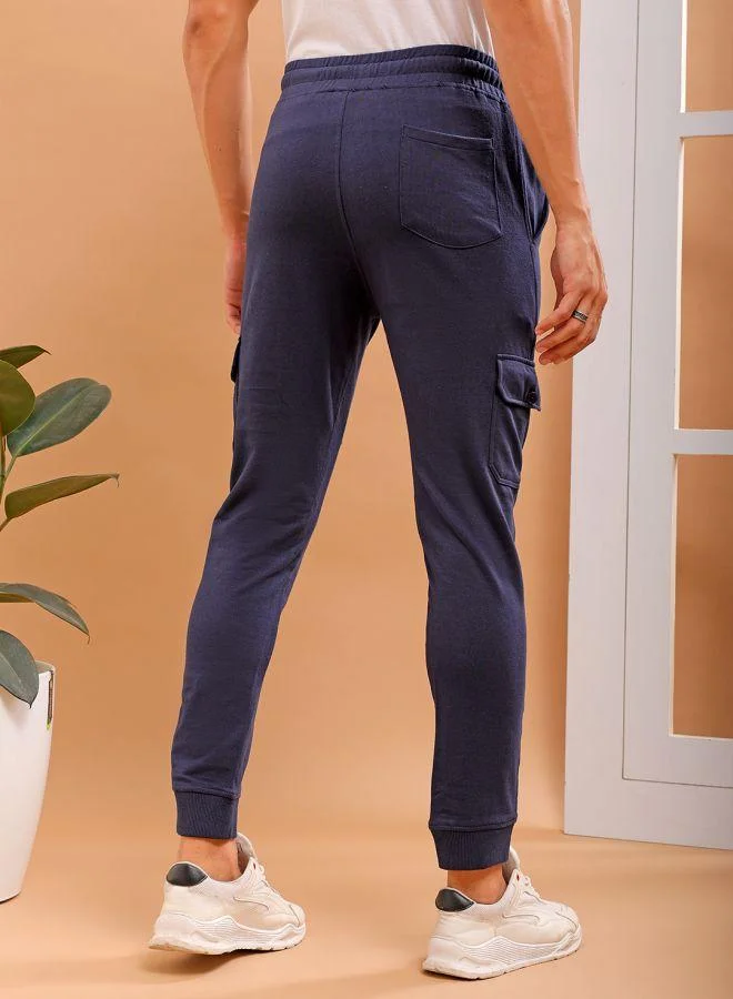 ذا انديان كراج كو Men Slim Fit Solid Mid-Rise Stretchable Knitted Jogger Trousers