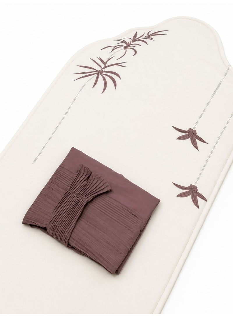 The Palm Prayer Set is a distinctive set consisting of a prayer rug with a foam lining in the shape of a mihrab, and a plain prayer garment with pleats and an attached headscarf. One large size for women.