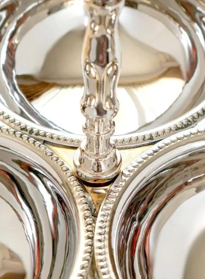 Casa Quesera Elevate your hosting experience with Zarif, a handmade silver-plated 2-tier serving stand crafted on a durable brass base. Featuring three integrated bowls and one central plate, this elegant piece is perfect for serving dry fruits, sweets, snacks, or as a stunning decorative centerpiece. Its intricate design, fine craftsmanship, and timeless shine make it an ideal choice for festive occasions, weddings, or luxury home décor.