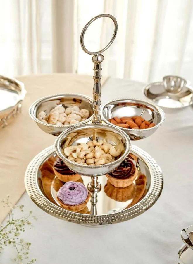 Casa Quesera Elevate your hosting experience with Zarif, a handmade silver-plated 2-tier serving stand crafted on a durable brass base. Featuring three integrated bowls and one central plate, this elegant piece is perfect for serving dry fruits, sweets, snacks, or as a stunning decorative centerpiece. Its intricate design, fine craftsmanship, and timeless shine make it an ideal choice for festive occasions, weddings, or luxury home décor.