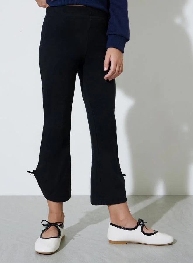 ستايلي Girls Black Ribbed Knit Flared Leggings with Bow Detail