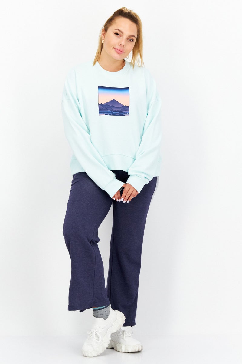 New Balance سترة نسائية واسعة المقاس بأكمام طويلة للأنشطة الخارجية، باللون الفيروزي - Image 4