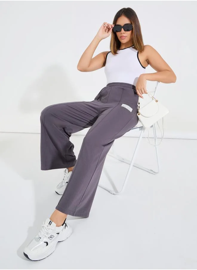 ستايلي High Waisted Wide Leg Pintuck Jogger with Badge Detail