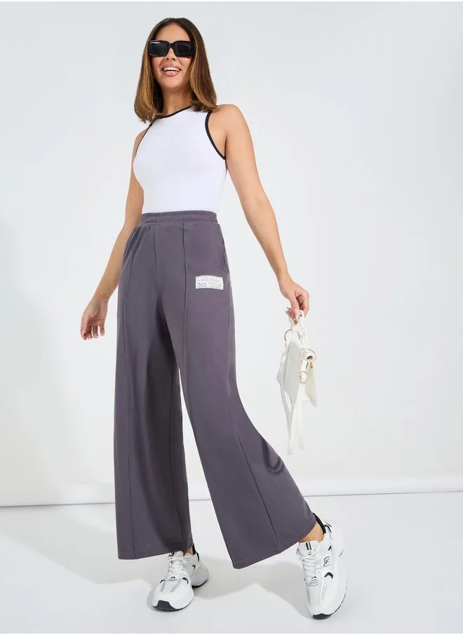 ستايلي High Waisted Wide Leg Pintuck Jogger with Badge Detail