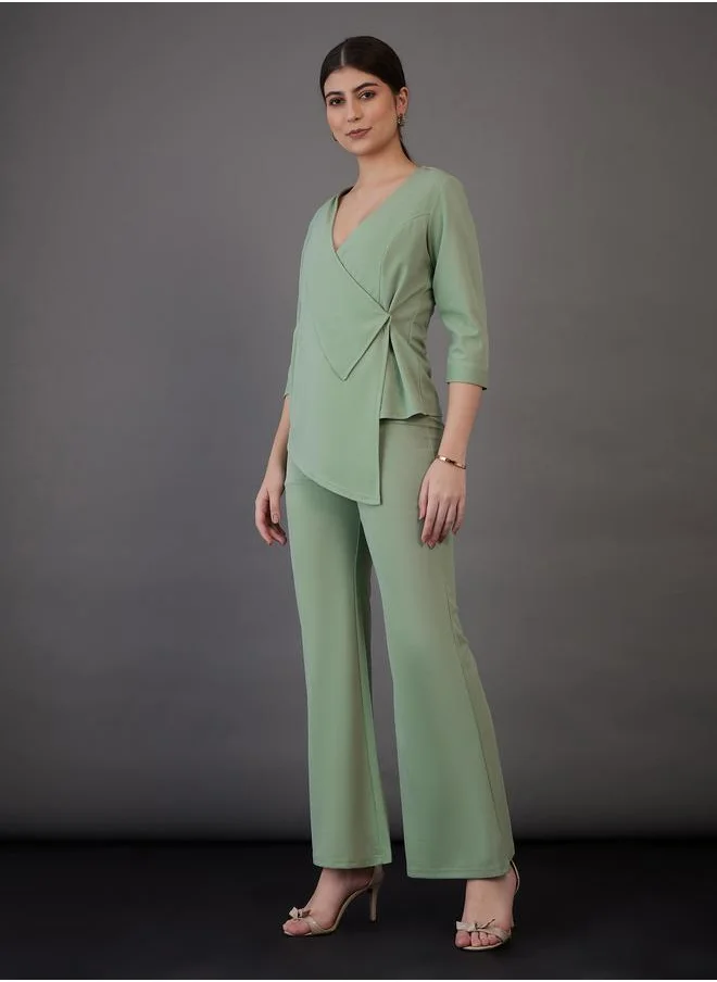 SASSAFRAS Asymmetrical Hem Wrap Top & Flared Pants Co-Ord by Styli