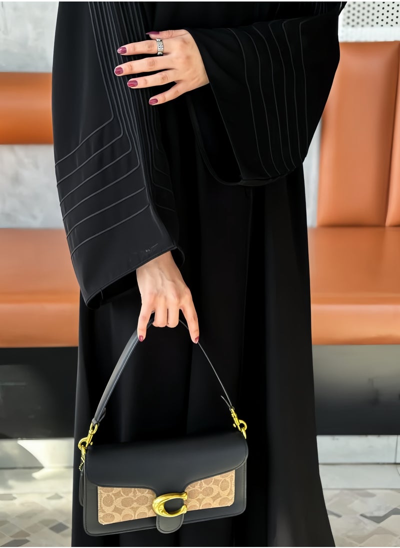 Saba abaya with elegant qitan detail offering a refined modest look with soft lines and a modern touch perfect for daily wear and simple occasions