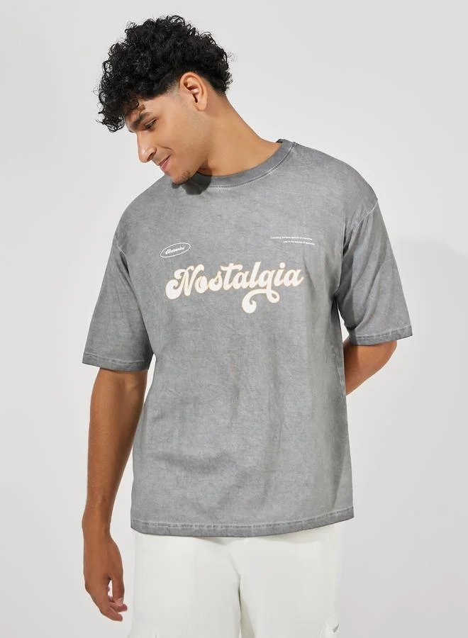 Styli Overdyed Washed Oversized T-Shirt with Slogan Print