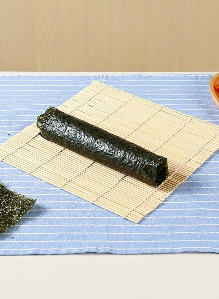 Make sushi effortlessly with this practical sushi mat and maker! Designed to help you create perfectly rolled sushi like a pro at home. Made from high-quality materials and easy to use, ensuring a fun cooking experience. Perfect for sushi lovers and Japanese cuisine enthusiasts! - Image 1