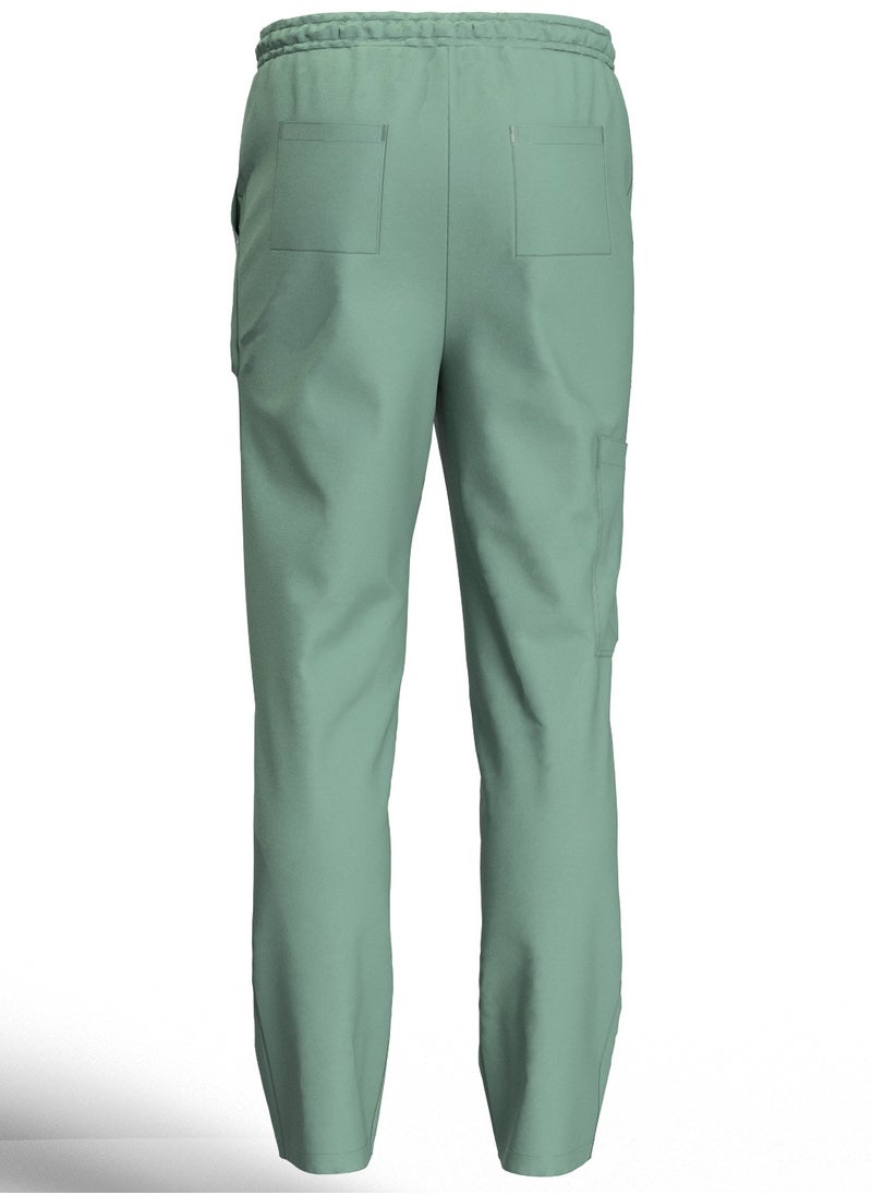 Doctor - Scrub Comfortable Olive Lycra fabric with many pockets is meticulously crafted to retain its color without fading with repeated washing - Image 1