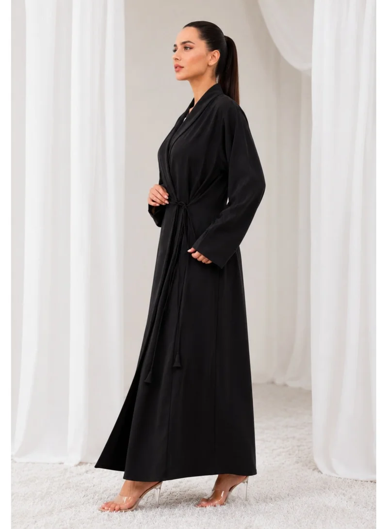 Nikias Overlap abaya on black crepe fabric with loop design on sleeves and front