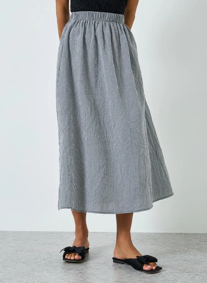 تايك تو تنورةة بحافة واسعة كاروهات وفتحة جانبية