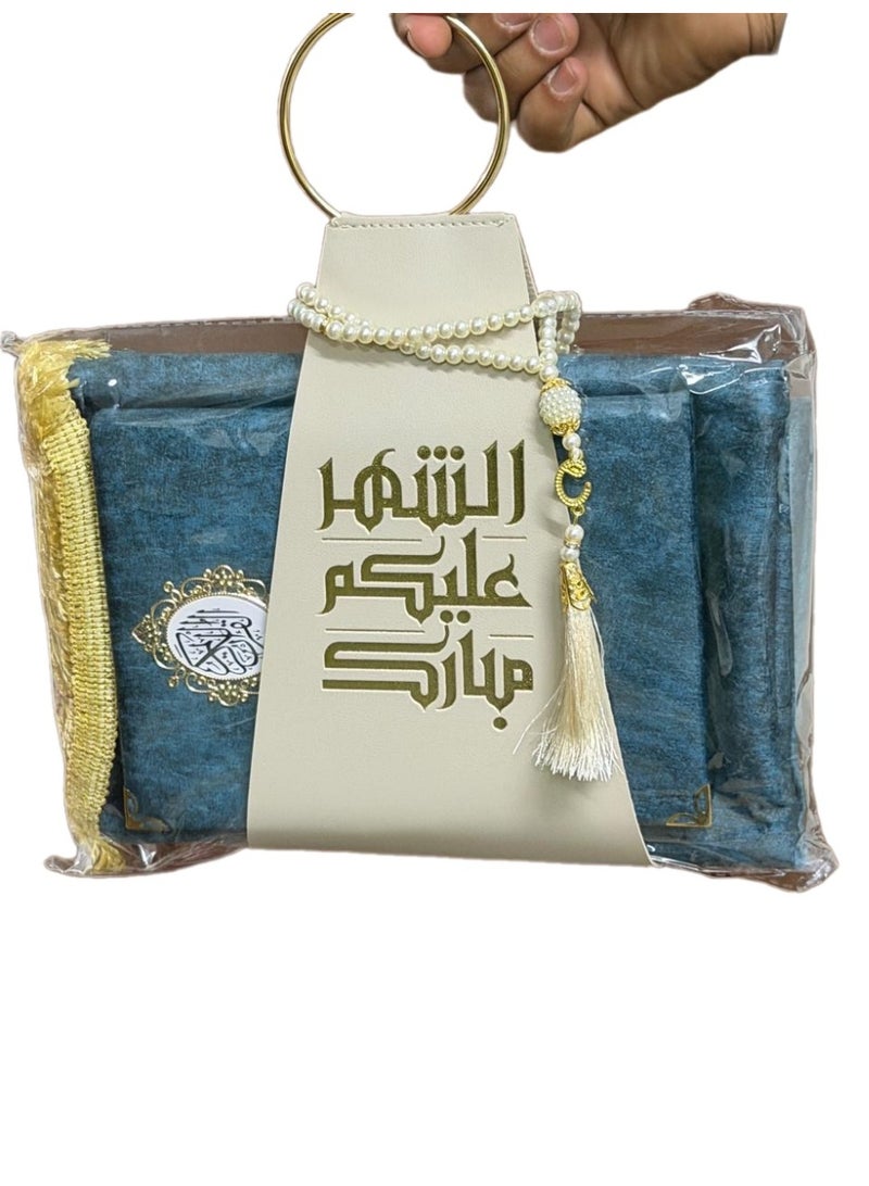A prayer rug, a Quran, and prayer beads, presented with a suitable strap, as a Ramadan gift.