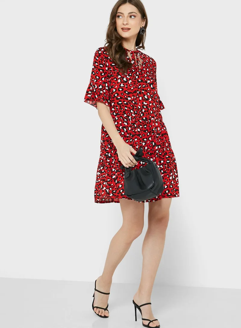 Ginger Shirred Neck Flared Cuff 
Tiered Printed Dress