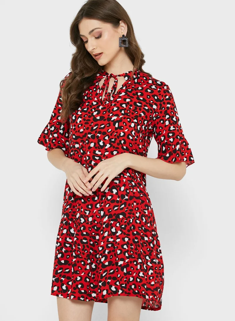 Ginger Shirred Neck Flared Cuff 
Tiered Printed Dress
