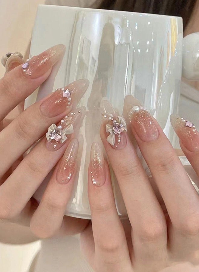 NIBEMINENT 24 قطعة أظافر صناعية، أظافر صناعية في علبة، أظافر صناعية طويلة على شكل لوز بلون بشرة موحد لامع، عقدة على شكل قلب حب نجمة زركون لؤلؤية، رقعة أظافر صناعية - Image 1