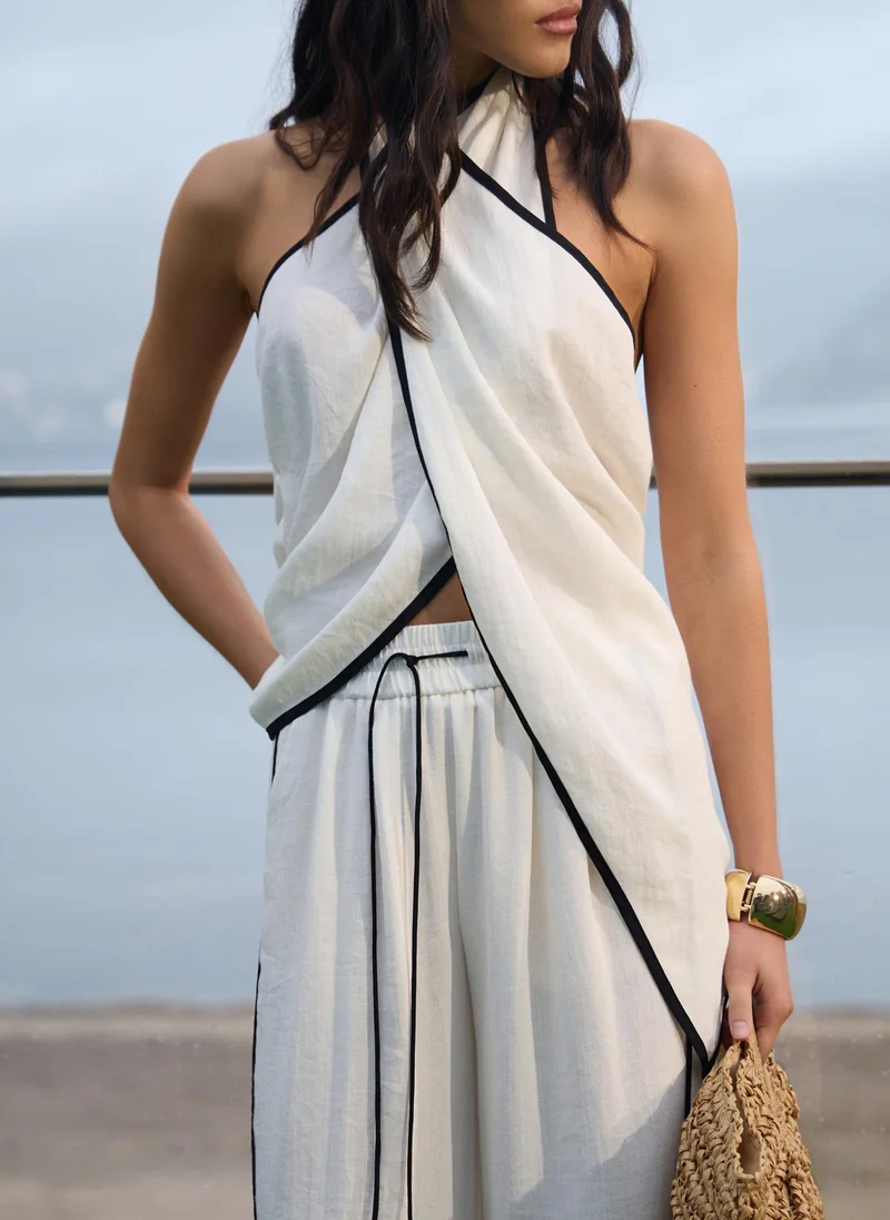 Draped top with halter collar and contrasting edging
