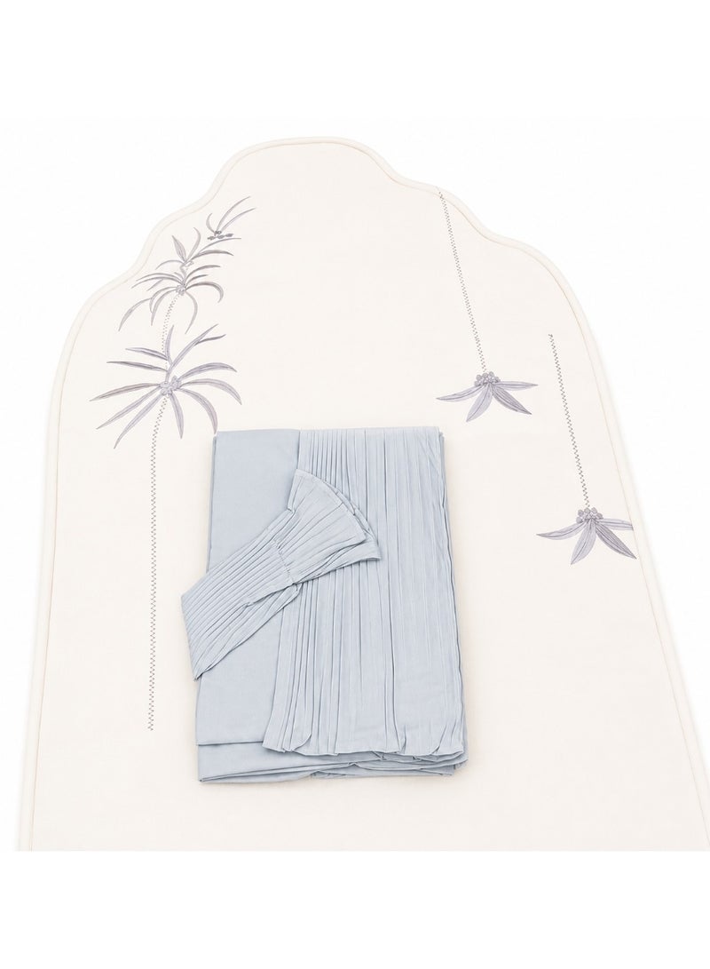 The Palm Prayer Set is a distinctive set consisting of a prayer rug with a foam lining in the shape of a mihrab, and a plain prayer garment with pleats and an attached headscarf. One large size for women.
