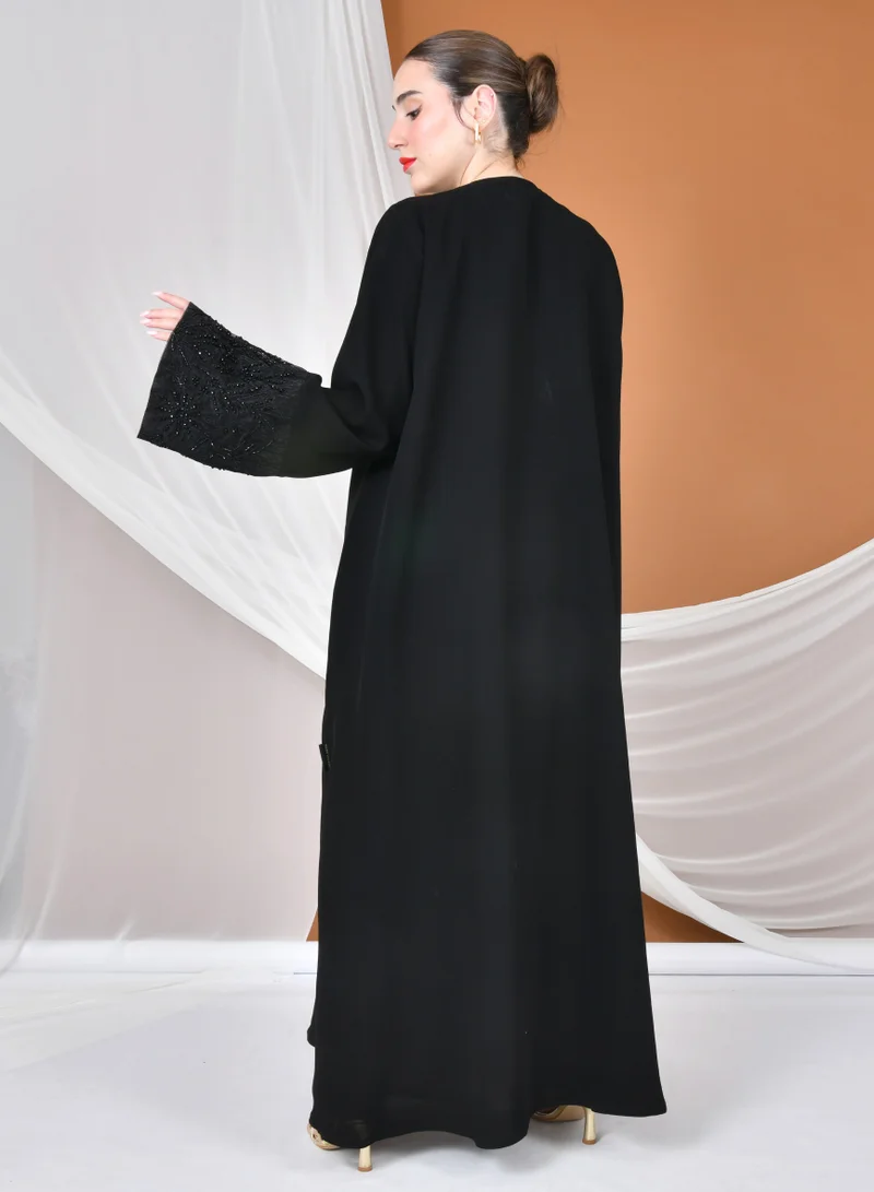 عبايات حوراء عباية لف سوداء بقصة انسيابية بكم واسع مزين بكلفة راقية
