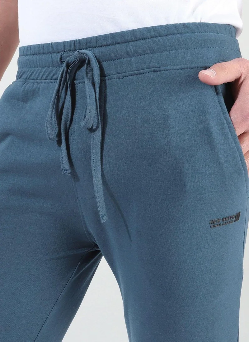 The Indian Garage Co Men Slim Fit Solid Mid-Rise Stretchable Knitted Jogger Trousers