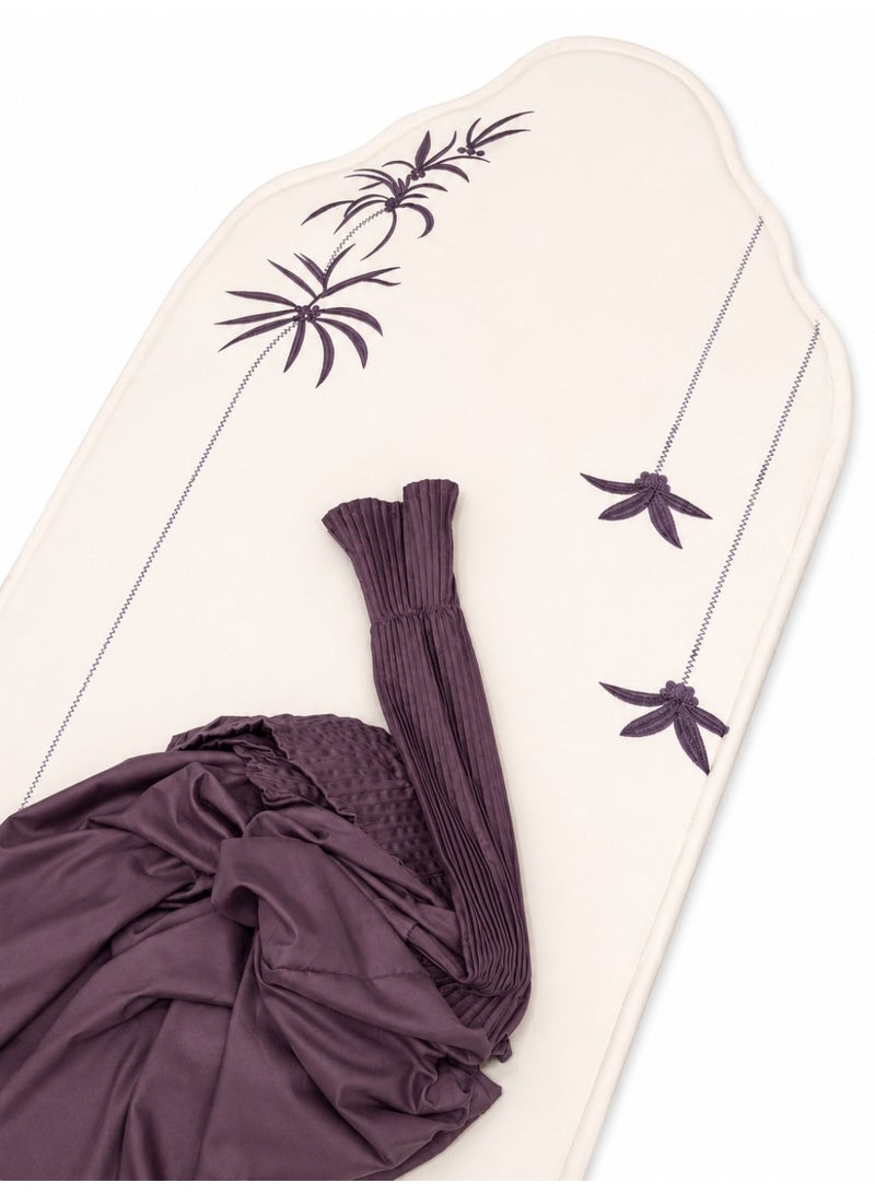 The Palm Prayer Set is a distinctive set consisting of a prayer rug with a foam lining in the shape of a mihrab, and a plain prayer garment with pleats and an attached headscarf. One large size for women.