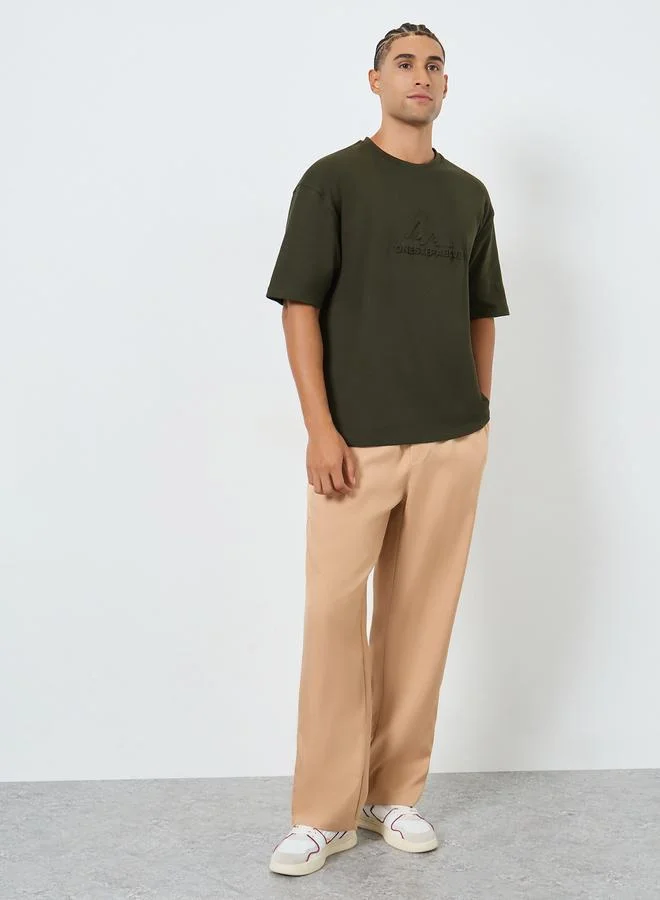 Styli Men Olive Graphic Embossed Oversized T-Shirt