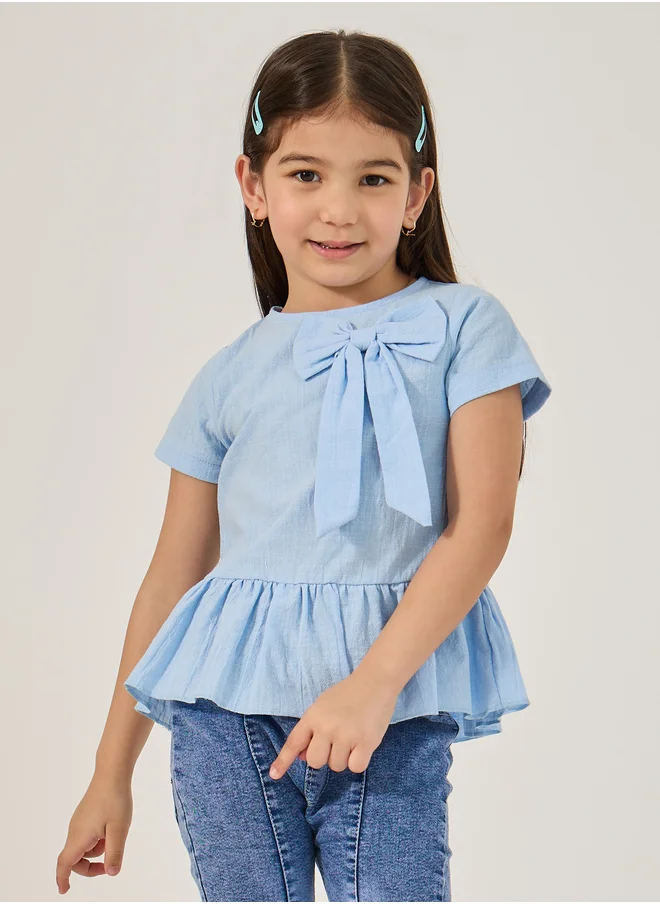 ستايلي Styli Solid Ruffled Hem Top with Bow Detail