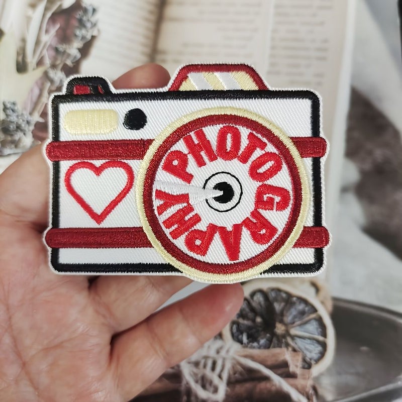 A Photography Themed Embroidery Patch Featuring A Heart Design For Leisure Use On Jackets Jeans Vests And Bags With Hot Melt Adhesive Backing For Sewing Or Ironing - Image 1