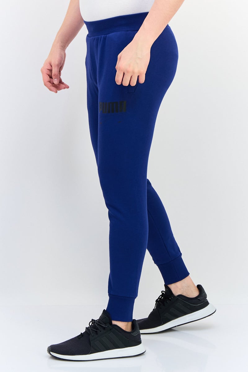 PUMA سروال رياضي خارجي للرجال بقصة عادية بشعار العلامة التجارية، أزرق - Image 3