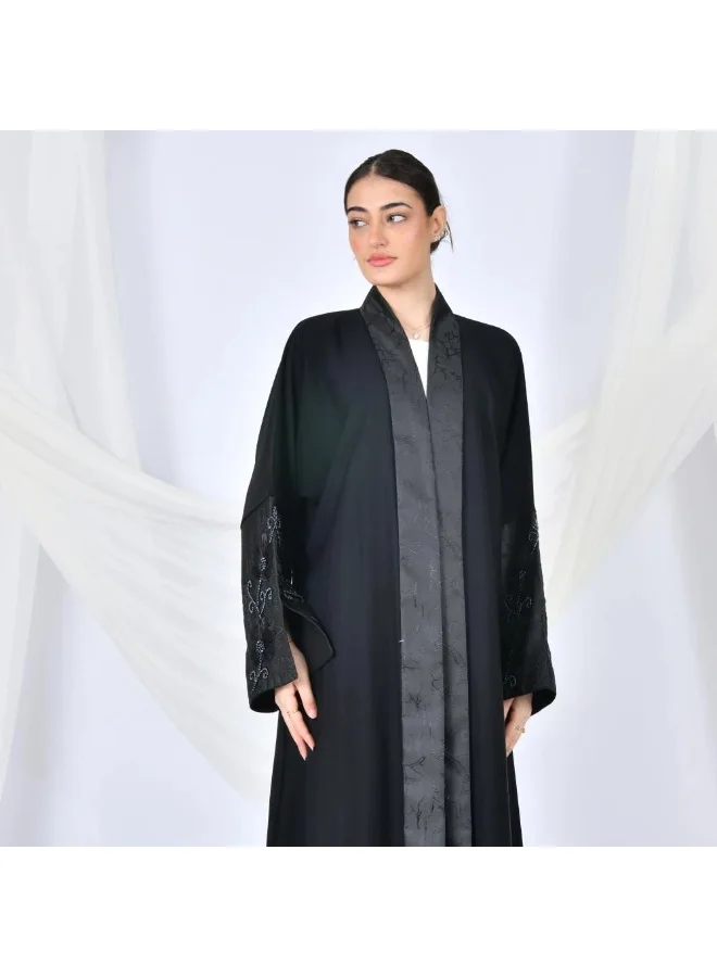 lamha abaya Black quarter-cloche wrap abaya with jacquard fabric and wide sleeves decorated with embroidery