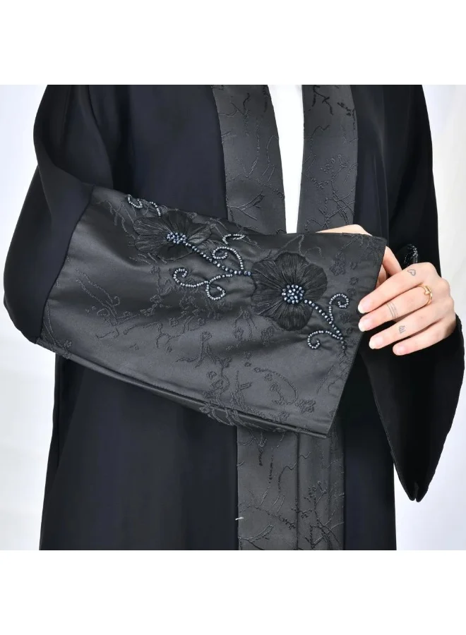 lamha abaya Black quarter-cloche wrap abaya with jacquard fabric and wide sleeves decorated with embroidery