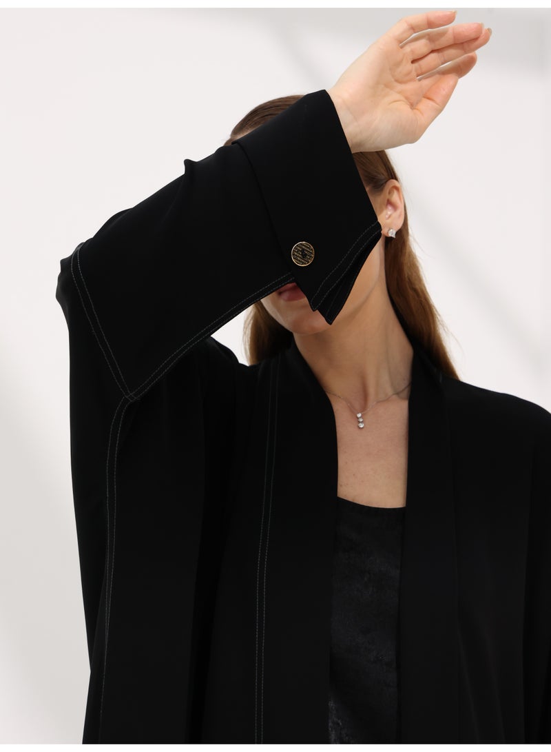 Khan&Co. Seven Seas Black Abaya in black crepe fabric with two silver KHAN&CO logo buttons - Designed by Abdullah Khan - Image 2