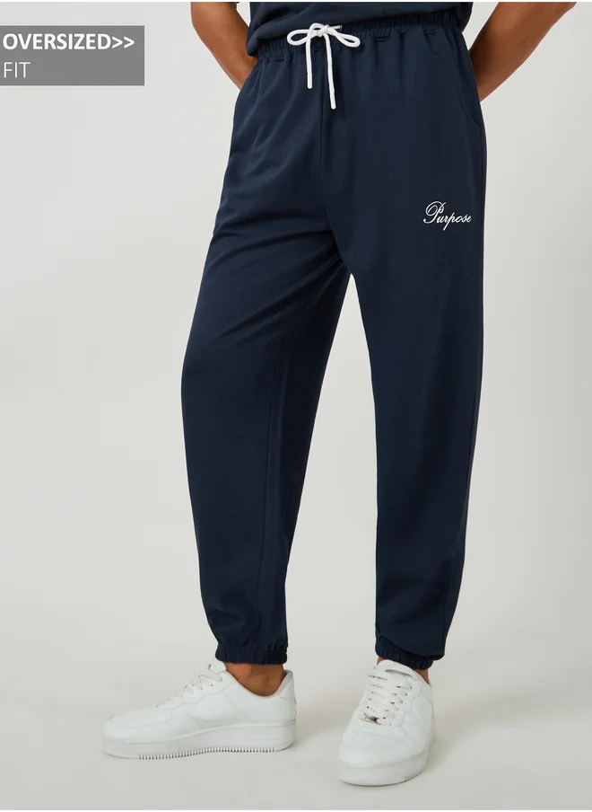 ستايلي Styli Minimal Slogan Print Oversized Joggers with Drawstring