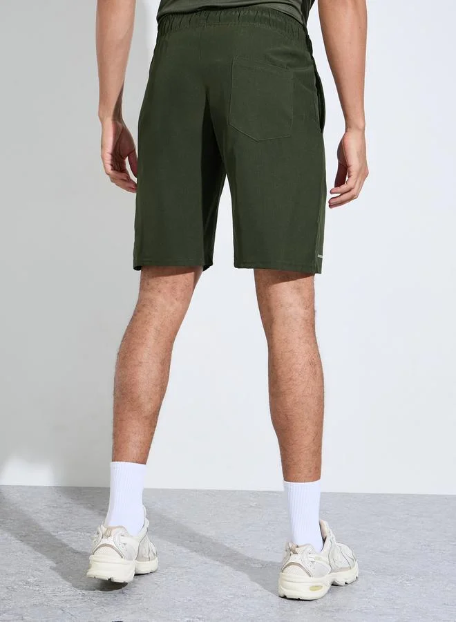 Styli  Olive Solid Drawstring Running Shorts with Side Pockets for Men | Best Price UAE