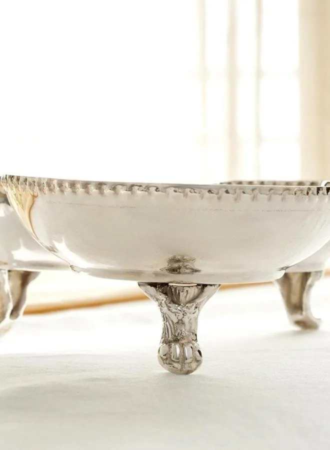 Casa Quesera Celebrate every occasion with this handcrafted 3-bowl silver-plated platter featuring a solid brass base, gracefully perched on a vintage-inspired  stand. Perfect for serving nuts, sweets, dips, or snacks, it combines timeless design with everyday functionality. A stunning centerpiece and a perfect gift for weddings, festivals, or housewarmings.