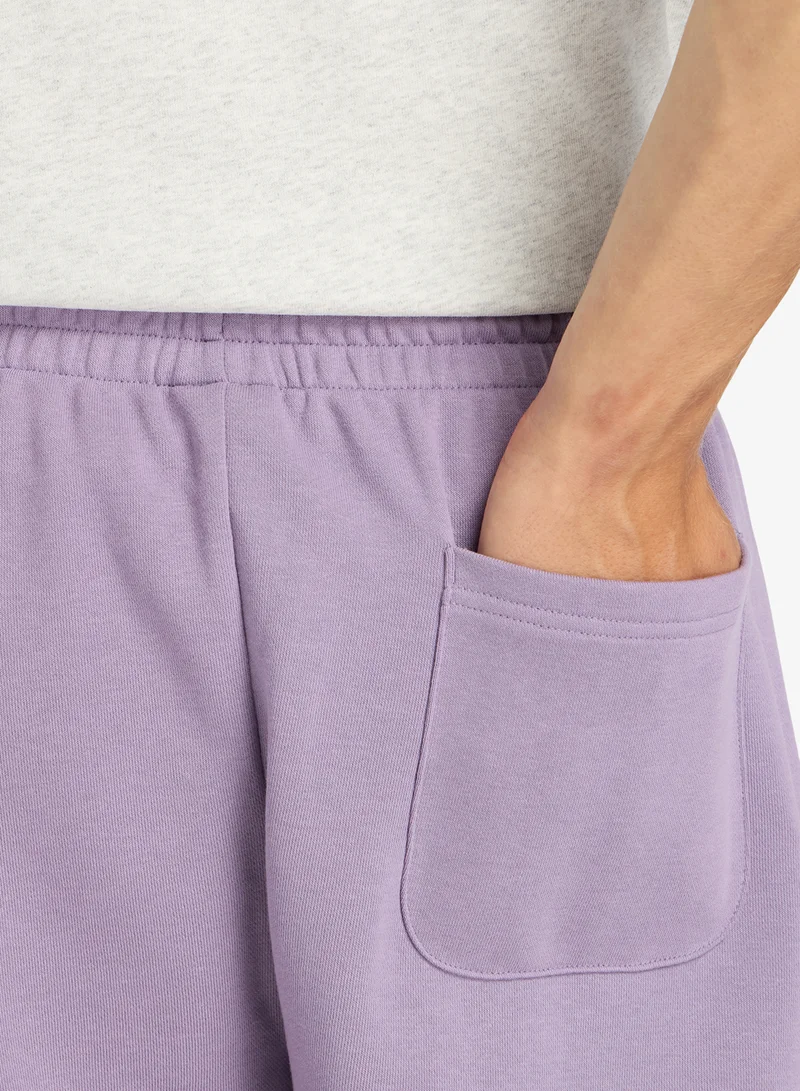 New Balance CANDIED VIOLET (AA5) 7" Essential French Terry Shorts for Men | Best Price UAE