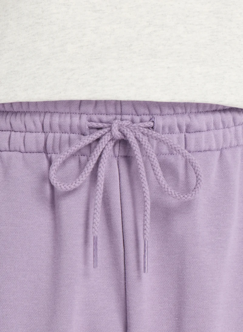 New Balance CANDIED VIOLET (AA5) 7" Essential French Terry Shorts for Men | Best Price UAE