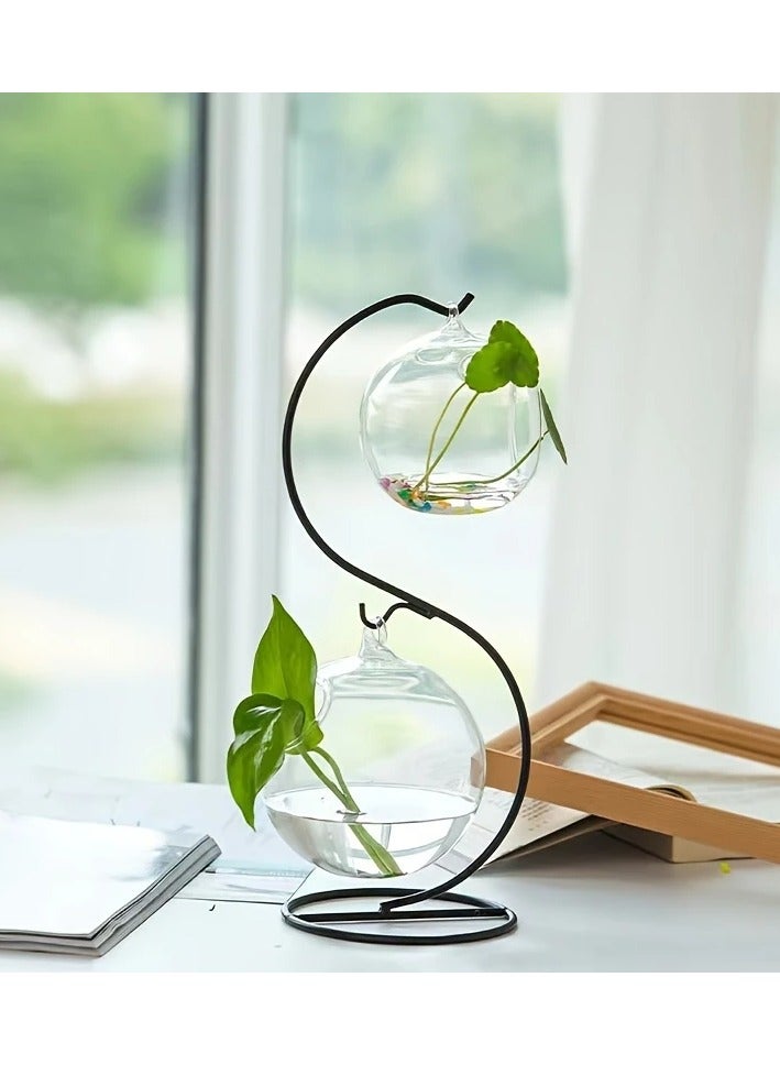Generic Only one piece, which is a wired metal holder in black color sold separately without a glass ball vase, glass lantern, plant basin, flowers, fish or glass charming balls is a fixed and durable wire iron hook holder and the round metal base keeps the pot stable and safe The decorative vase holder does not sway or fall thanks to the creative design and the modern idea in which you put a special glass ball pot for hanging to decorate the garden or The balcony or by the window or on your desk Some put a small golden or orange fish in it, others put plants, some mini garden, and some a luminous candle as desired and its design enters with most home decorations The piece is the holder without the pot - Image 4