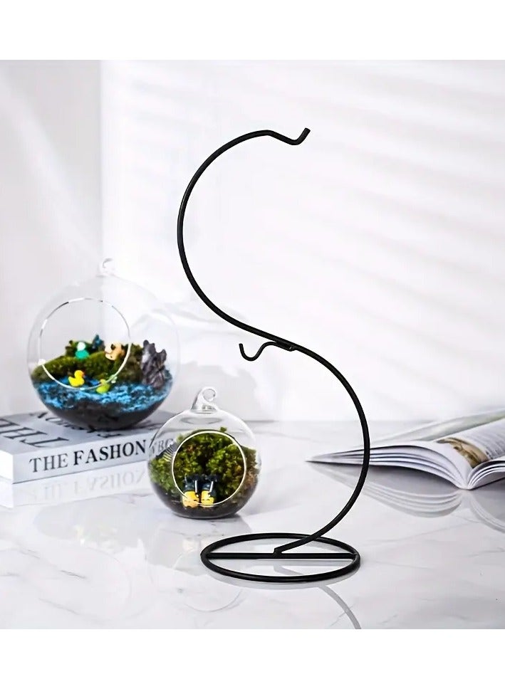 Generic Only one piece, which is a wired metal holder in black color sold separately without a glass ball vase, glass lantern, plant basin, flowers, fish or glass charming balls is a fixed and durable wire iron hook holder and the round metal base keeps the pot stable and safe The decorative vase holder does not sway or fall thanks to the creative design and the modern idea in which you put a special glass ball pot for hanging to decorate the garden or The balcony or by the window or on your desk Some put a small golden or orange fish in it, others put plants, some mini garden, and some a luminous candle as desired and its design enters with most home decorations The piece is the holder without the pot - Image 1