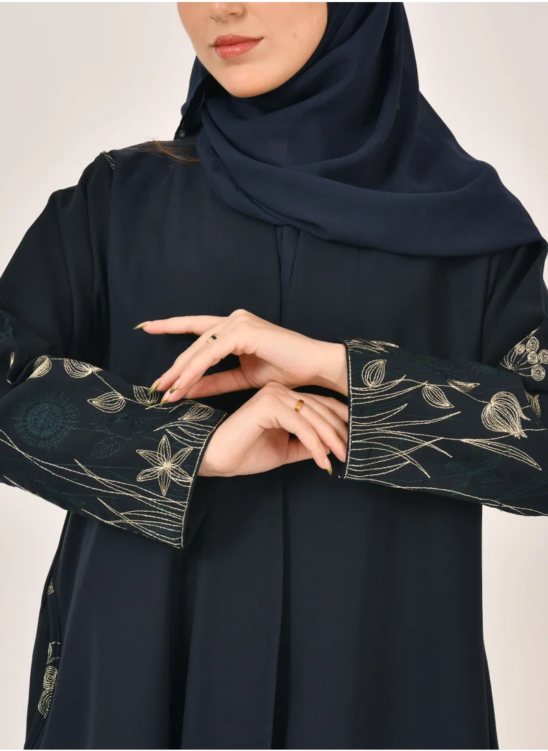 عبايات حوراء عباية لف كحلية بتطريز شجري ذهبي واخضر وجيوب على جوانب العباية