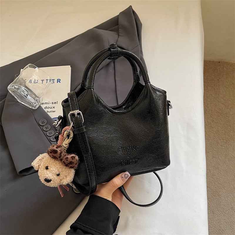 Simple bucket bag for women, new niche design, casual commuter shoulder bag, trendy and versatile crossbody bag. - Image 1