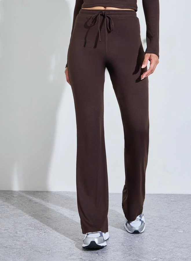 Styli Active  Brown Solid Long Sleeves Crop Top And Flared Leggings Active Set for Women | Best Price UAE