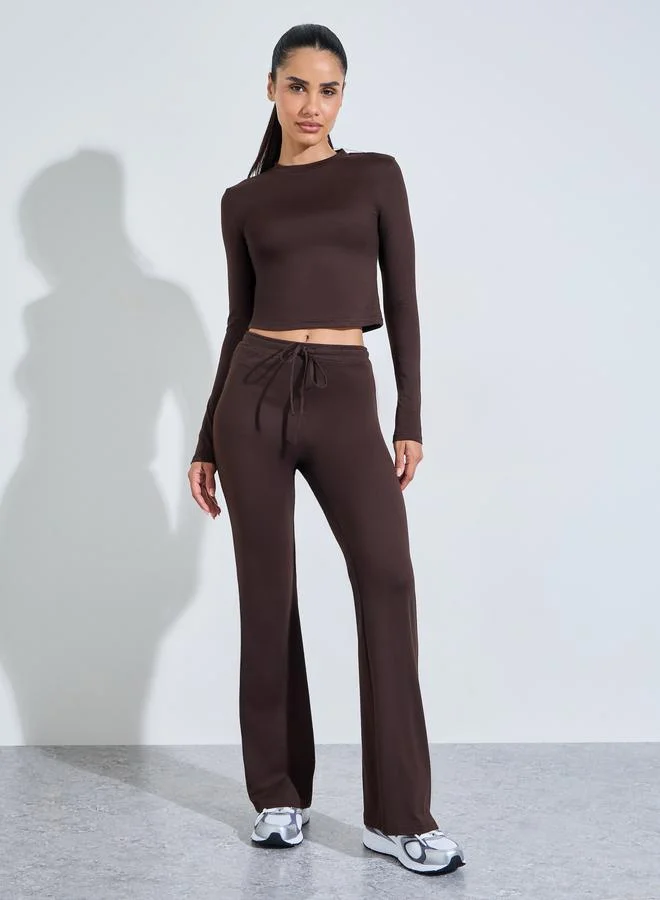 Styli Active  Brown Solid Long Sleeves Crop Top And Flared Leggings Active Set for Women | Best Price UAE