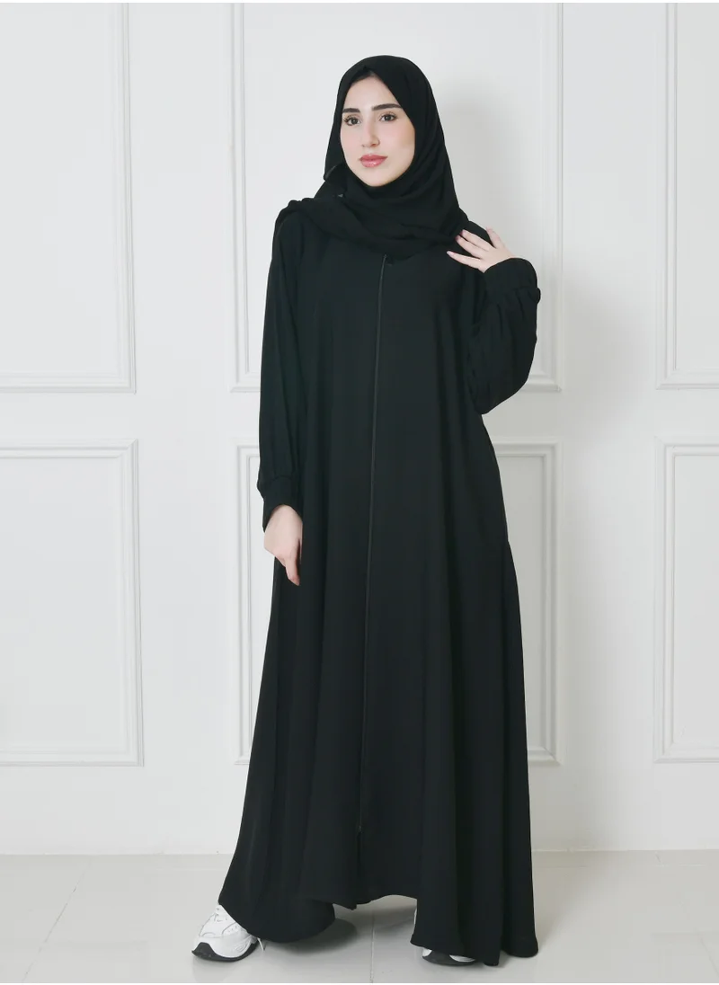 HAWRAA ABAYA A distinctive black closed quarter cloche abaya with a fitted veil and finger-slit sleeves