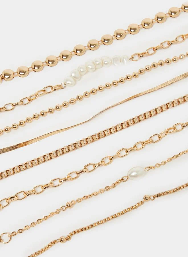 Styli  Styli Set of 8 - Gold Tone Layered Bracelets for Women | Best Price UAE