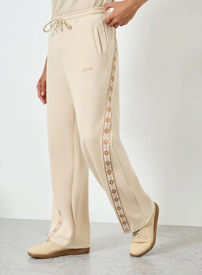 Men Beige Side Taping Print Oversized Joggers