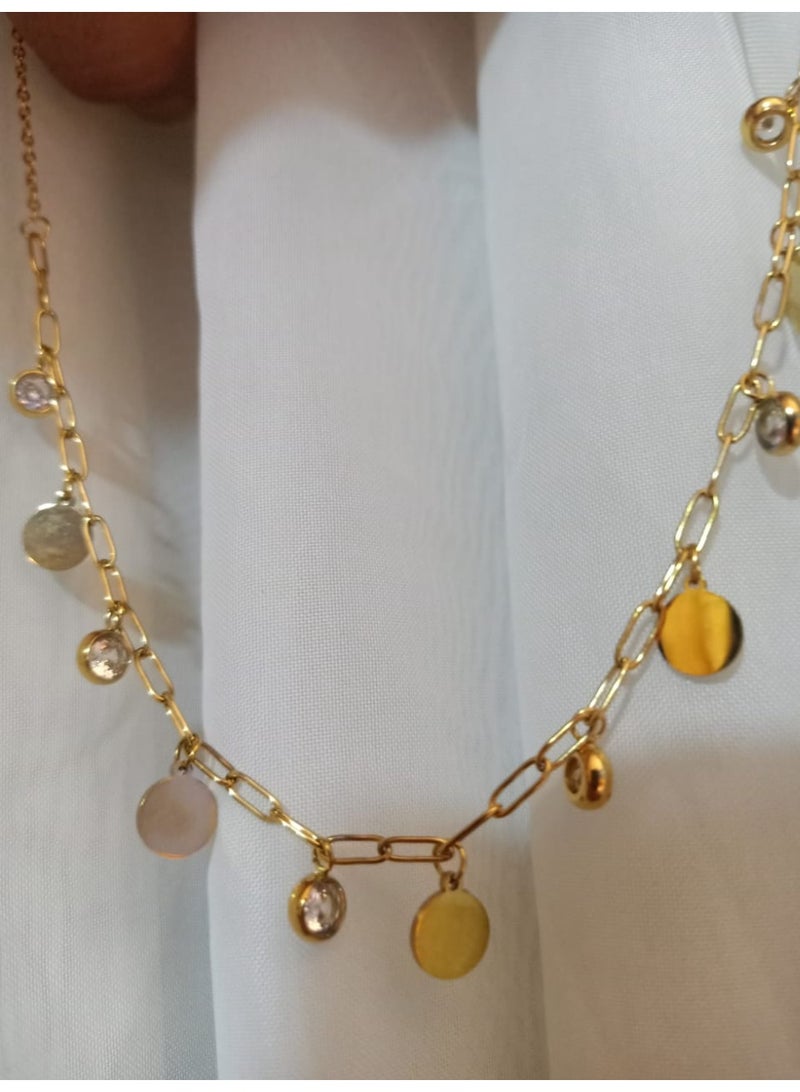 Luxuria A charming necklace crafted from gold-plated stainless steel. This design features a delicate pendant in the form of circular disc-shaped charms and clear gemstones, scattered on a modern chain, giving it a look that is both elegant and classic. - Image 3