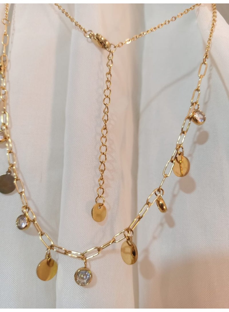 Luxuria A charming necklace crafted from gold-plated stainless steel. This design features a delicate pendant in the form of circular disc-shaped charms and clear gemstones, scattered on a modern chain, giving it a look that is both elegant and classic. - Image 4
